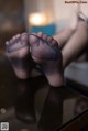 A pair of black stockings sitting on top of a table.