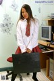 A woman in a school uniform holding a briefcase.