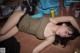 A woman laying on the floor next to cans of beer.