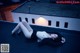 A woman laying on top of a roof next to a building.