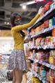 A woman wearing a face mask in a grocery store.