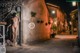 A naked woman standing in the middle of a street at night.