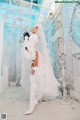 A woman in a wedding dress and boots posing for a picture.