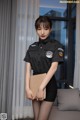 a woman in a police uniform posing for a picture