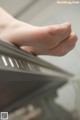 A close up of a person's foot on a piano.