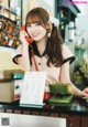 A woman sitting at a counter talking on a phone.