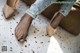 A woman's feet in a pair of nude colored shoes.