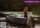 A woman sitting on a boat in the water.