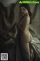 A nude woman sitting on top of a bed.