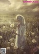 A woman in a white dress standing in a field of flowers.