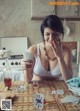 A woman sitting at a table with playing cards.