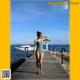A woman in a bathing suit standing on a dock.