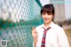 A young woman in a school uniform posing for a picture.