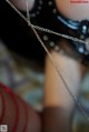 A close up of a woman wearing fishnet stockings and a necklace.