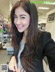 A woman with long brown hair standing in a store.