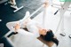 A woman is doing a bench press in a gym.