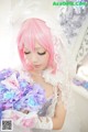 A woman in a wedding dress holding a bouquet of flowers.