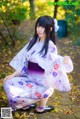 A woman in a kimono is posing for a picture.