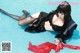 A woman in a black and white outfit laying in a pool.