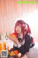 A woman sitting at a table with a bowl of fruit.