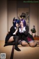 A couple of women sitting on top of a tatami mat.