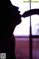 A silhouette of a woman kissing a man's hand.