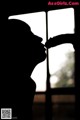 A silhouette of a woman kissing a man's hand.