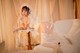 A woman in a wedding dress sitting on a couch.