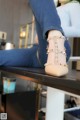 a woman sitting on top of a table with her legs crossed