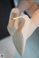 A close up of a woman's shoes on a table.