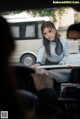 A woman sitting in the driver's seat of a car.