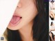 A woman with long black hair sticking out her tongue.