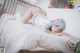 A woman laying on top of a bed in a bedroom.