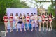 A group of women in bikinis posing for a picture.