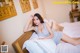 A woman laying on top of a bed in a bedroom.