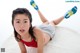 A young girl laying on a white rug with her legs up.