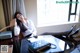 A woman sitting at a desk with her legs crossed.